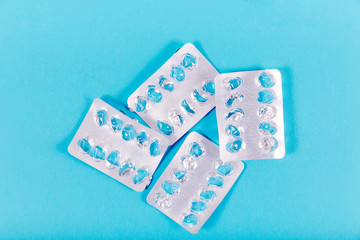 Empty plastic pill packs on blue background