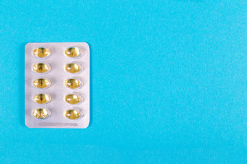 Pack of pills - fish oil - on a blue background
