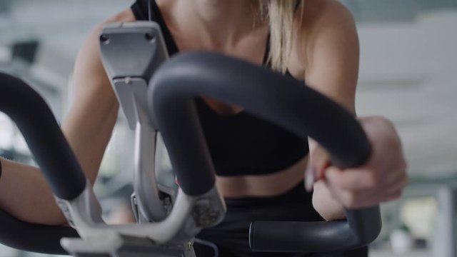 Handheld view of sporty woman working out with exercise bike.  Shot with RED helium camera in 8K