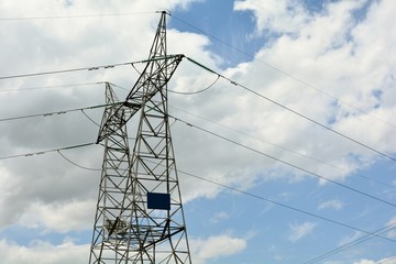 electricity pylon against blue sky