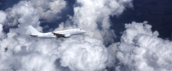 Executive jet with clouds in the background.