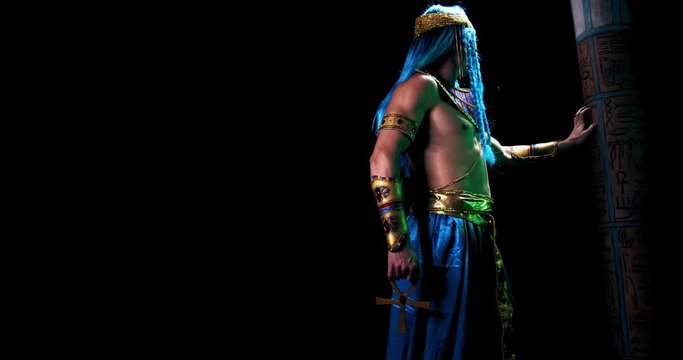 Egyptian god of wisdom and writing Thoth with ankh in hand on black background