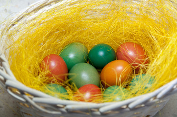 Colored Easter eggs in basket. Selective focus.