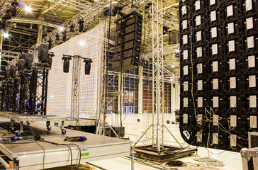 Moving head spotlight devices on a truss. Line array speakers. Big led screen. Installation of...