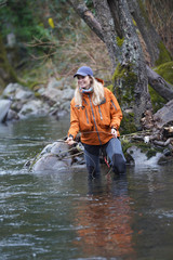 woman fly fishing in river