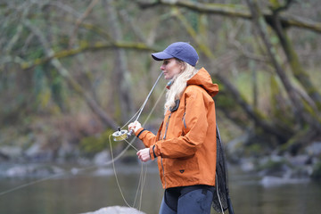 woman fly fishing in river