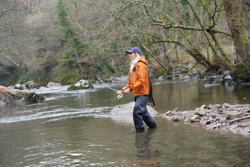 woman fly fishing in river