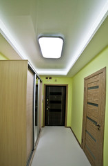 the interior is modern, big, long corridor in shades of green