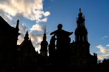 Obraz premium Silhouettes of Dresden Cathedral of Trinity Hofkirche and Dresden Castle Hausmannsturm. Dresden, Germany. November 2019
