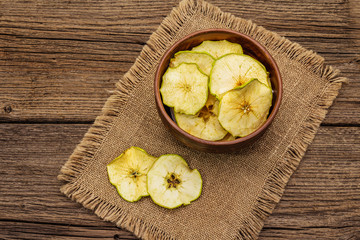 Dried slices of apple in bowl. Fruit snack, healthy eating concept