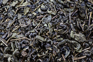 Green dry tea close-up. Tea leaves for a large amount. Photo for screen saver.