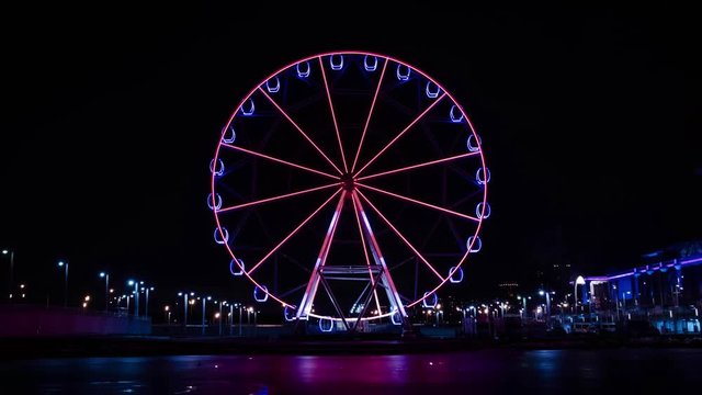 Time lapse ferris wheel at the amusement park at night.
