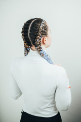 Girl with pigtails, two braids with the addition of artificial material in blue