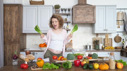 Happy Pregnancy Of Woman Dancing With Green Salad On Kitchen