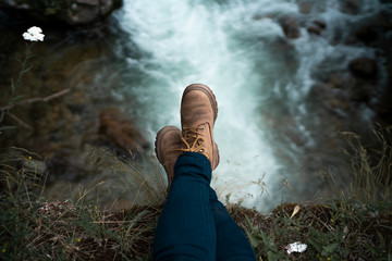 A shot of girl's legs with waterfall in background