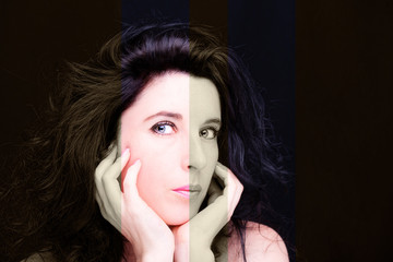 Young attractive woman with long black hair on dark background