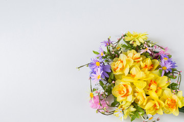 on a white background a wreath of wild flowers and daffodils