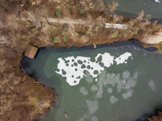 Aerial drone view. Frosty pattern on a thin crust of ice on the lake.