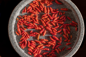 Dried small red chilies in a stone bowl