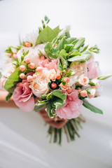 beautiful wedding bouquet with red, pink and white flowers, roses and eucalyptus, peonies, calla lilies