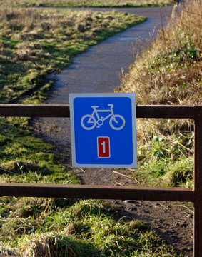 The blue painted square sign showing the route of the Scottish Coastal Cycle path at the Village of Johnshaven in Aberdeenshire.