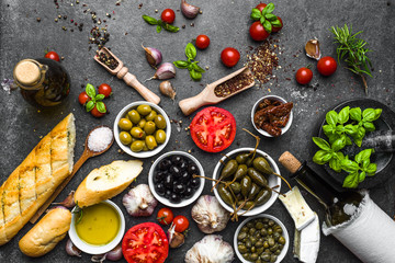 Mediterranean food background. Cooking ingredients on dark stone.