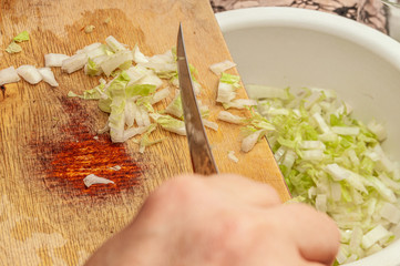 finely chopped Chinese cabbage raked from a wooden board