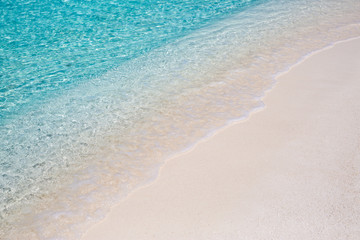 Fototapeta na wymiar Peaceful beach nature. Soft blue ocean wave on clean sandy beach. Soft beautiful ocean wave on sandy beach