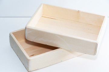 Empty wooden box. Made of pine, on a light white background.