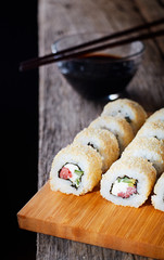 Sushi roll sushi with prawn, avocado, cream cheese, sesame.