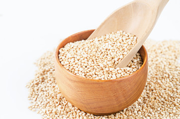 quinoa seeds in wooden spoon.