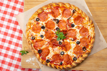 Pepperoni pizza close-up with various ingredients decorated with Basil, an assortment of traditional Italian fast food
