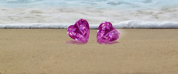 Fototapeta na wymiar Heart shaped pink diamond Laying on the beautiful sand
