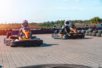 A group of racers on karts are approaching the finish line in an active battle for first place in...
