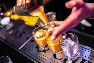 Expert bartender making cocktail at the bar