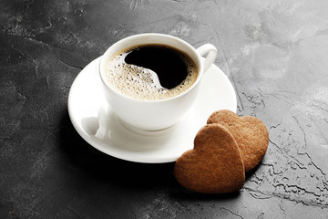 Delicious homemade cookie hearts with a cup of coffee on a dark background. Top view. Place for text.