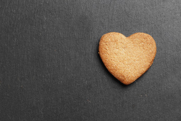 Delicious homemade cookie hearts on a dark background. Top view. Place for text.