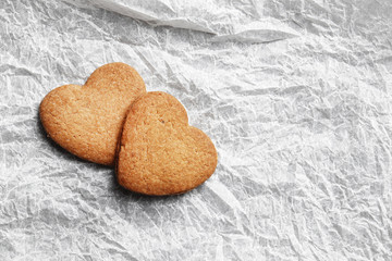 Delicious homemade cookie hearts on parchment paper