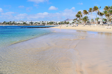 Beautiful beach of Las Cucharas in Costa Teguise, Lanzarote, Canary Islands. View of the blue sea,...