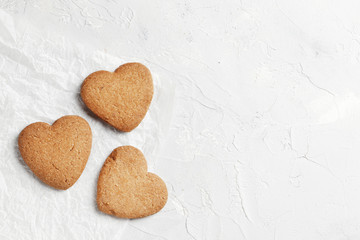 Delicious homemade cookie hearts  on a light background. Top view. Place for text.