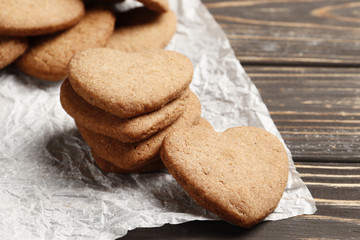 Delicious homemade cookie hearts on parchment paper. Top view. Place for text.