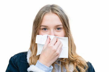 a girl wipes her nose with a handkerchief