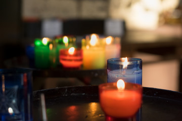 Group of colorful candles with glass candlesticks