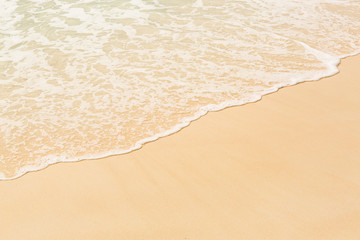 Fototapeta na wymiar Tropical beach background with soft wave and sand