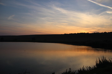 Clouds on Hungarian lake at sunset time.