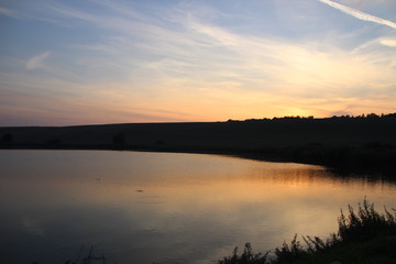 Fototapeta na wymiar Clouds on Hungarian lake at sunset time.