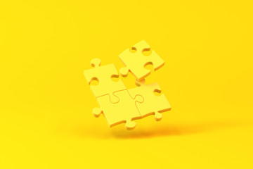 Jigsaw pieces isolated over a yellow background. Minimalist concept.