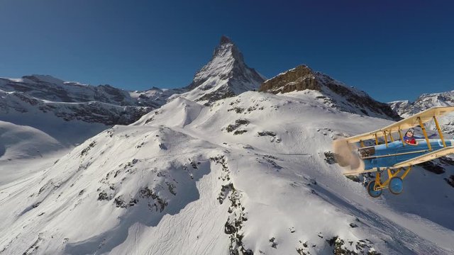 Child girl pilot aviator in airplane flying over winter mountains. The travel for ski by air concept