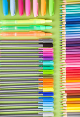 Fototapeta premium Colored pencils, testers on green background 