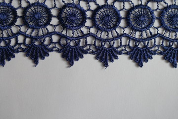 Horizontal edge of navy blue crochet lace